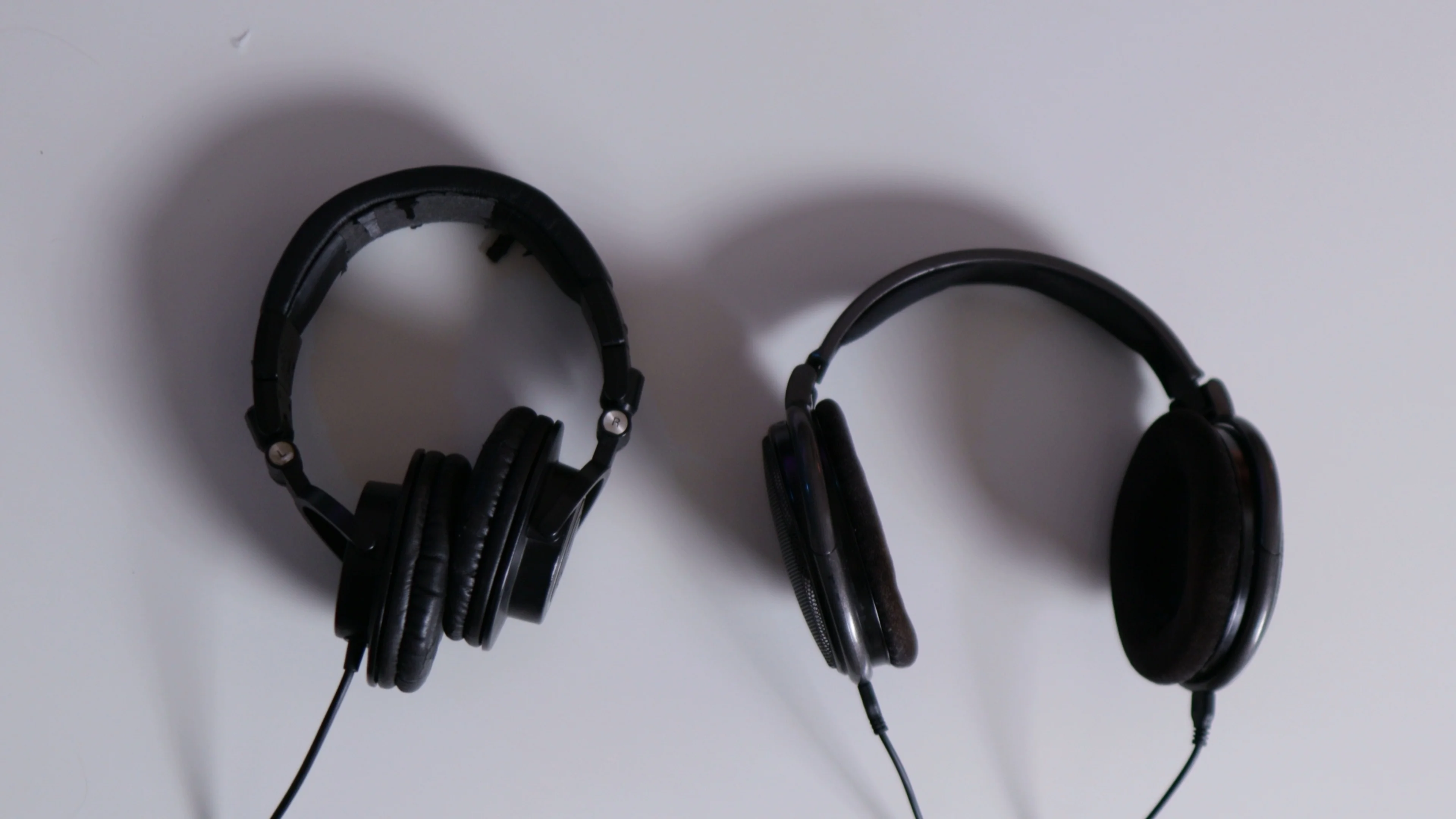 Closed-back and open-back studio headphones used for active listening and critical analysis