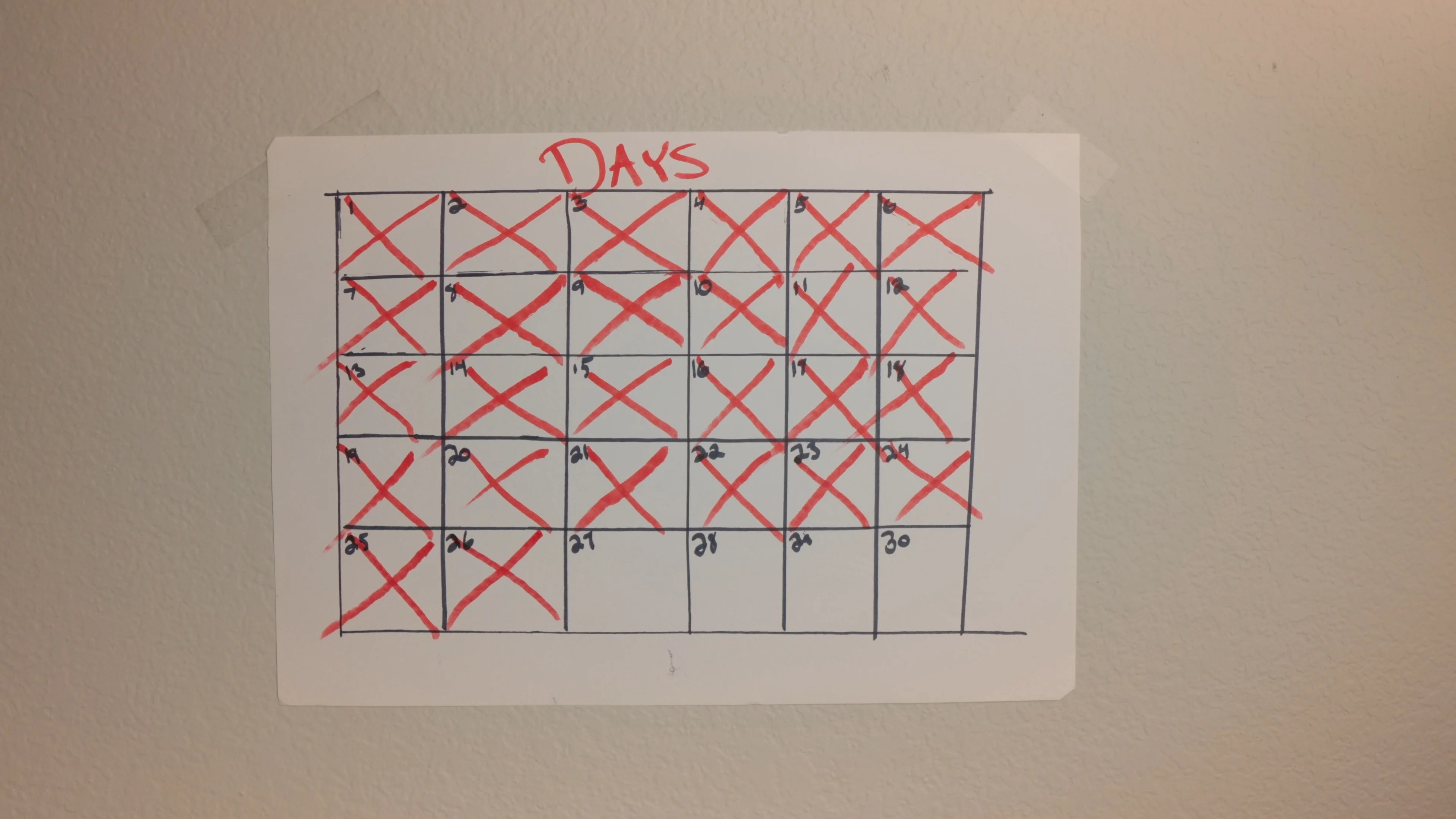 Hand-drawn calendar tracking daily songwriting progress, reflecting a disciplined lyric-writing routine