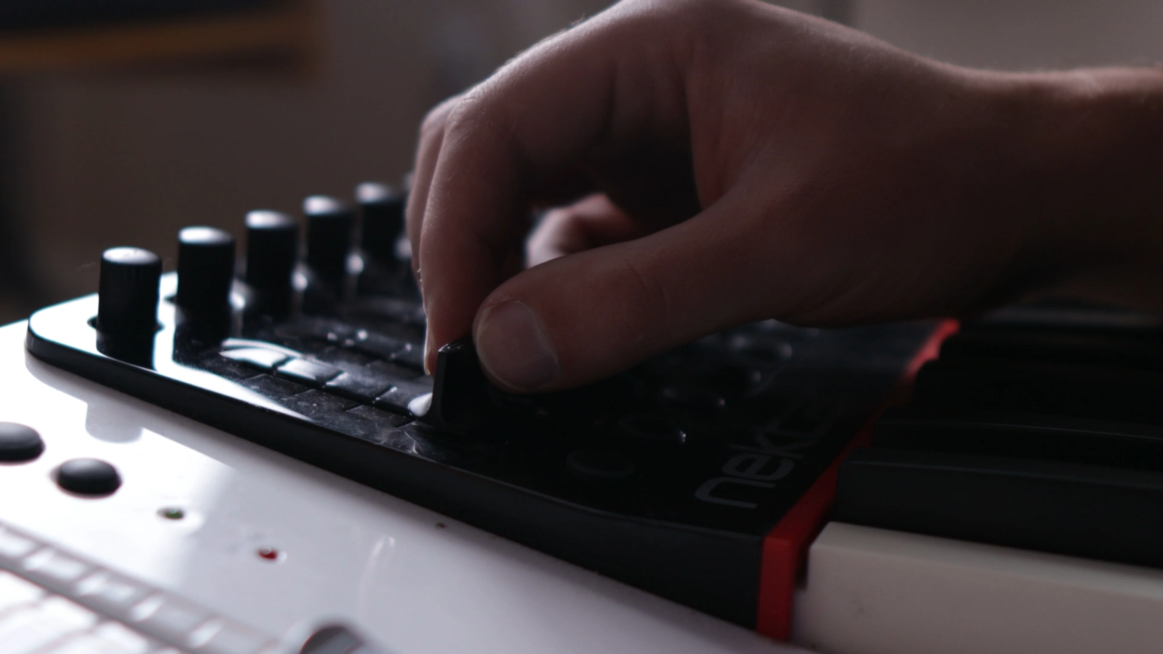 Producer adjusting MIDI controller knobs while organizing vocal preset files in FL Studio