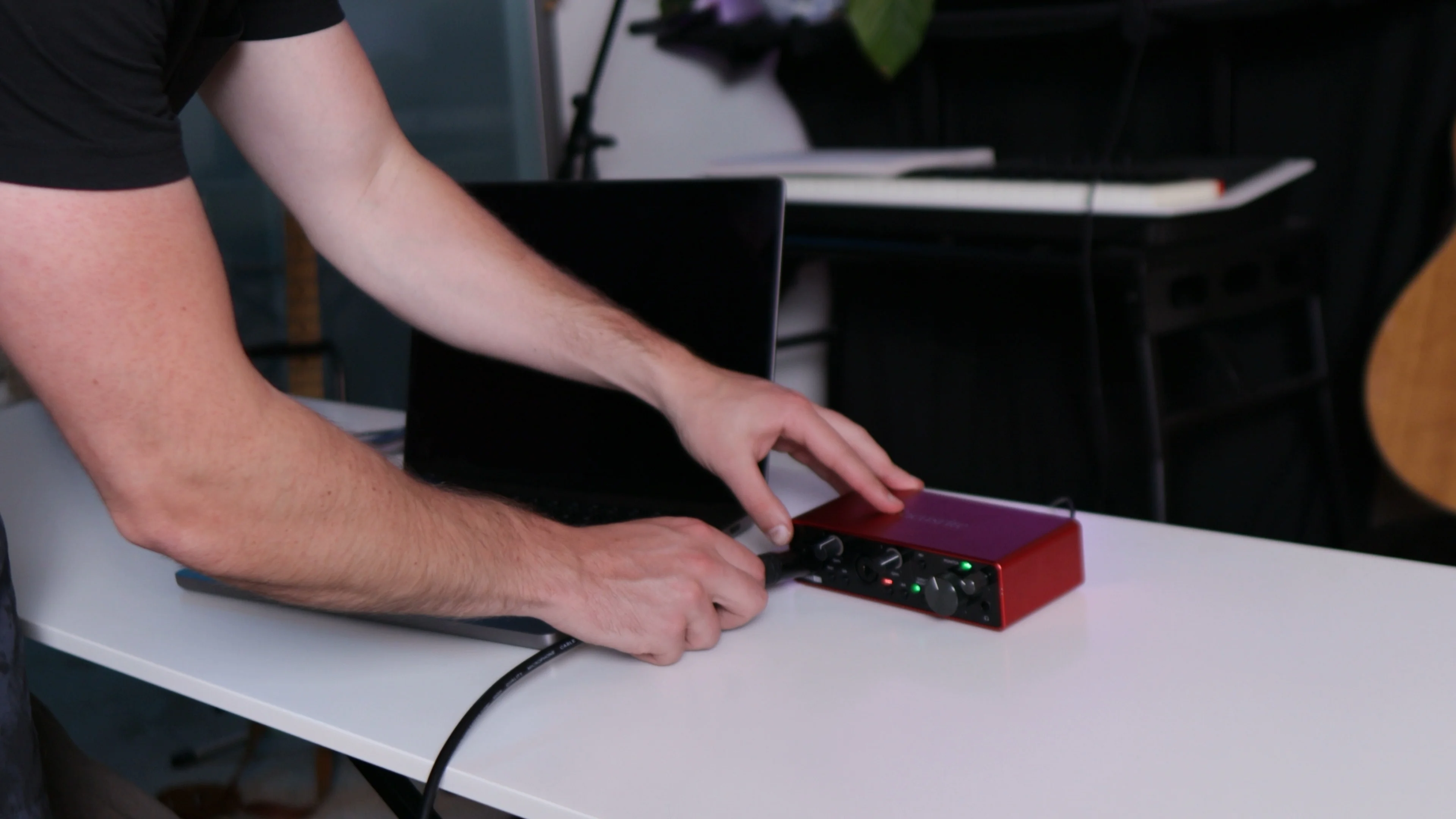 Mattie setting up recording space by connecting audio interface for iPhone vocal recording session