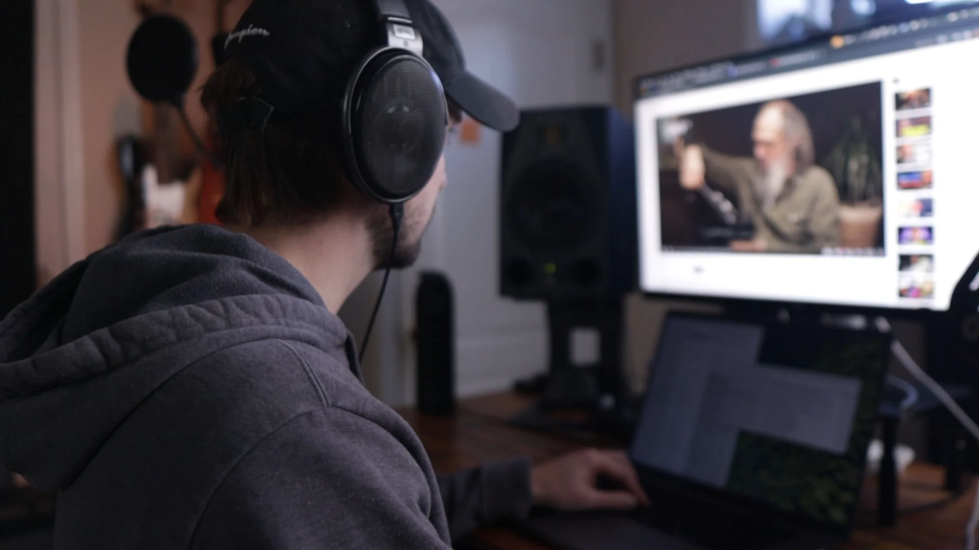 Mattie wearing headphones working at a computer, preparing a free gift resource for readers