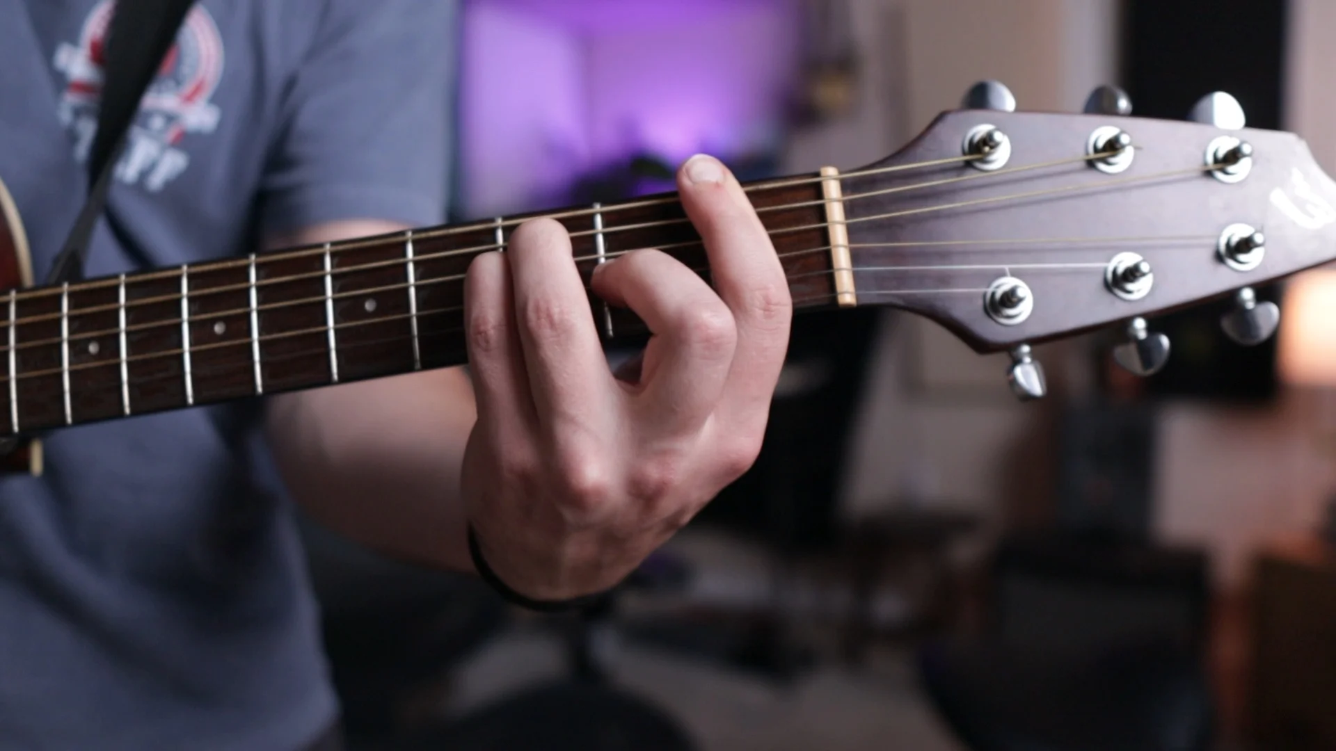 Mattie demonstrating different finger positions for reordering the same four chords