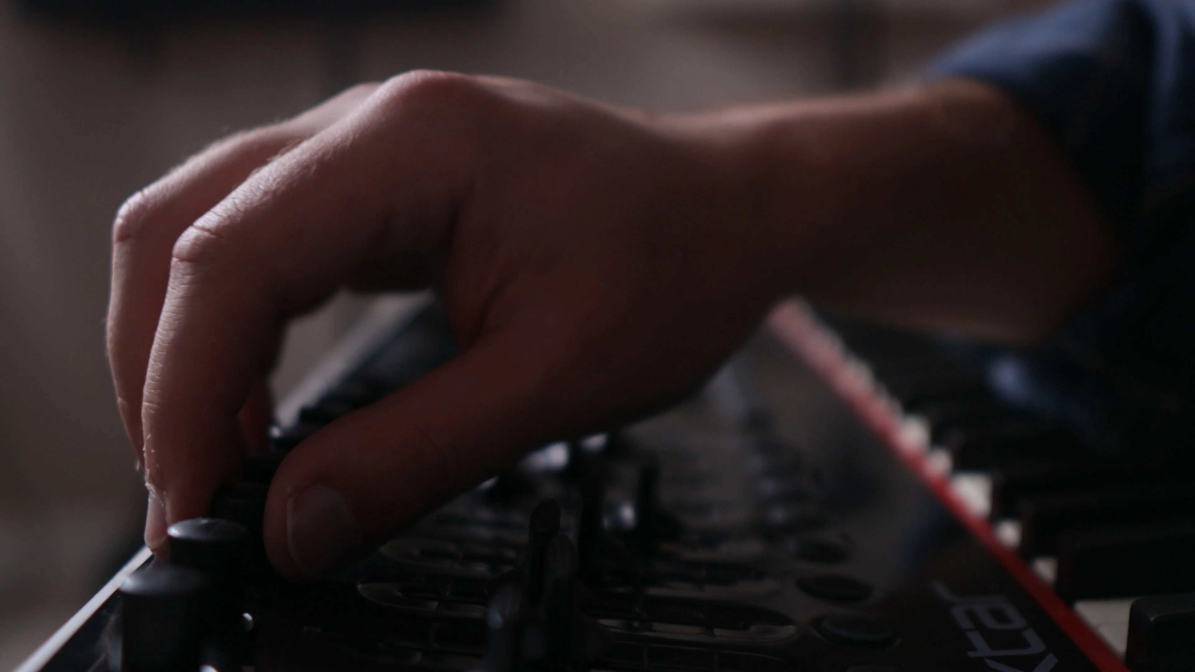 Mattie adjusting controls during a vocal mixing session to fine-tune dynamics