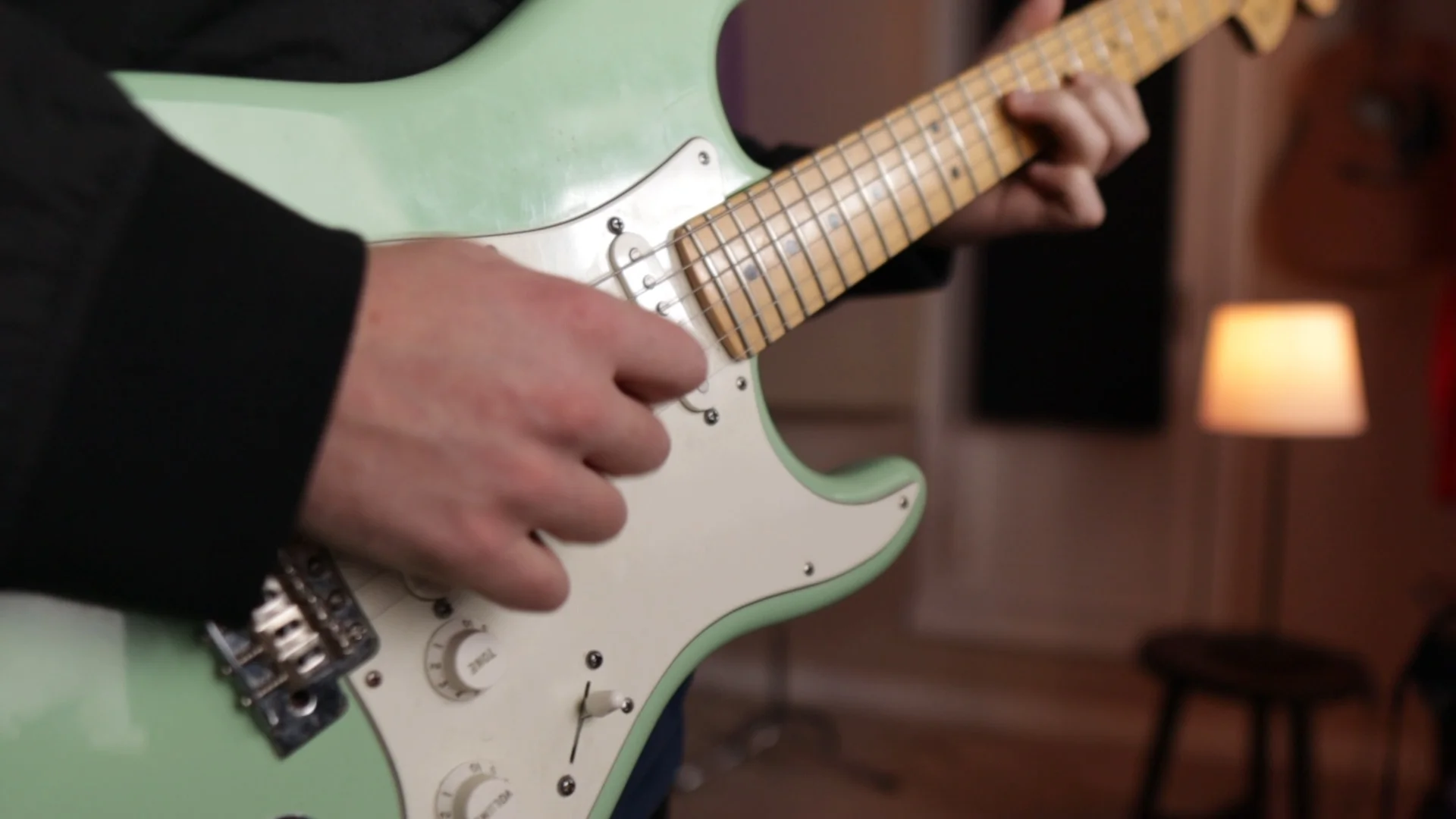Close-up of electric guitar representing live instrument performance versus AI-generated bass and keys in Logic Pro